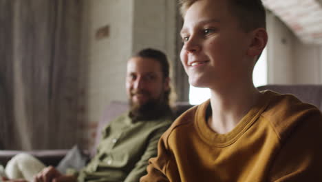 caucasian man and boy in the living room