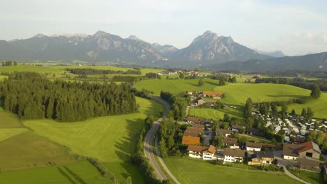 Aerial-Establishing-Shot-of-Rural-Village-in-Europe,-Mountain-in-Background
