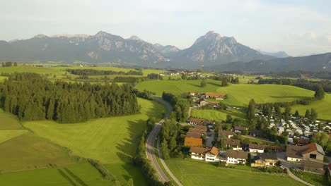 aerial establishing shot of rural village in europe, mountain in background