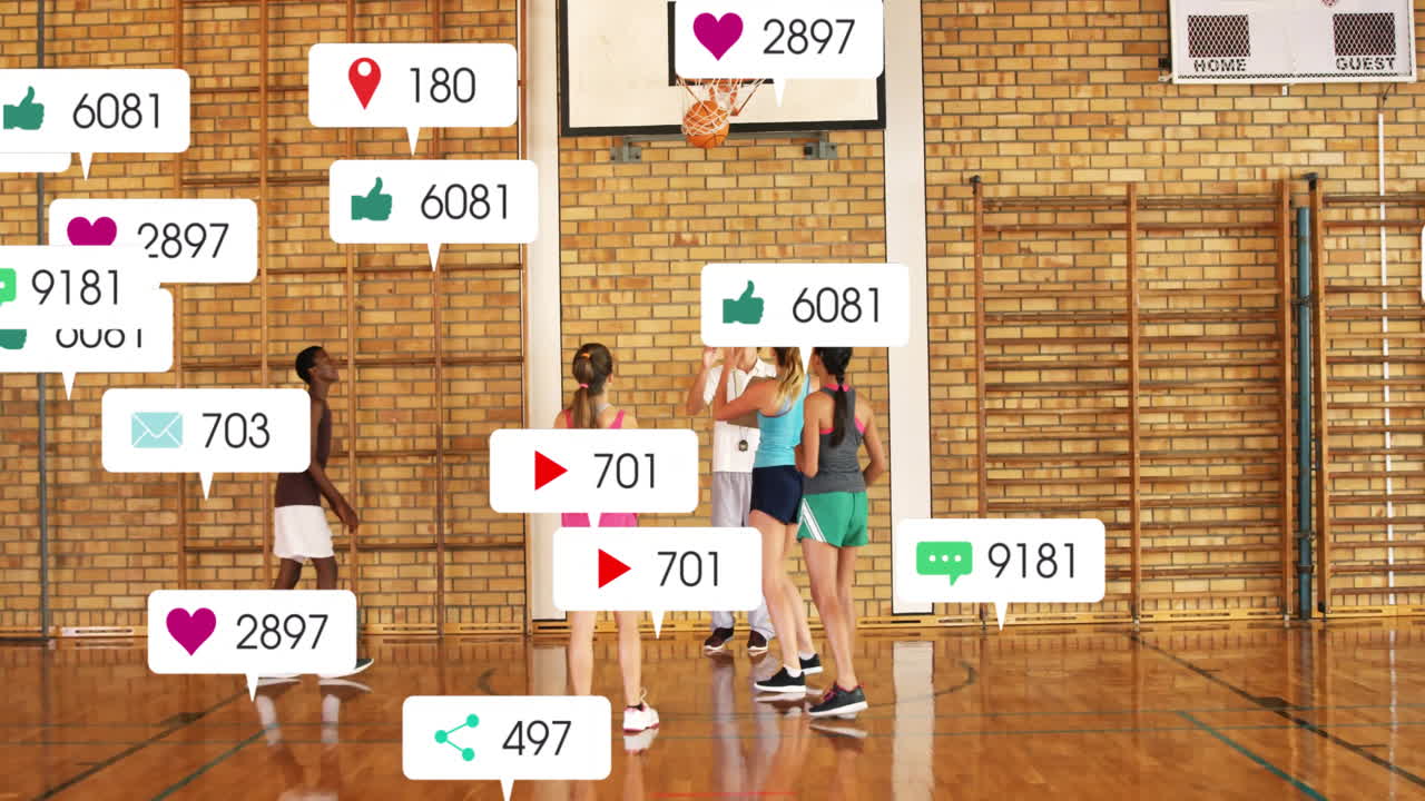In school gym, basketball players practicing with animation of social media icons