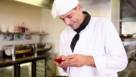 handsome chef sending a text message