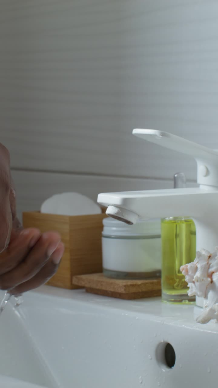 Man washing his face in the bathroom