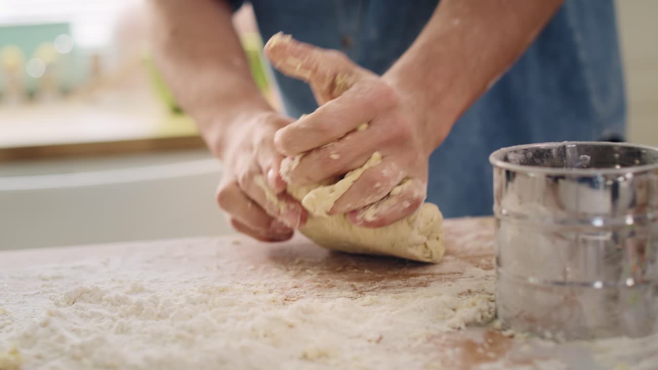 Handheld view of man&rsquo;s hands kneading dough