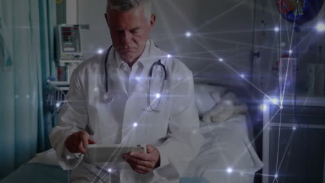 animation of network of connections over caucasian male doctor using tablet