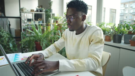 black businessman using laptop in office