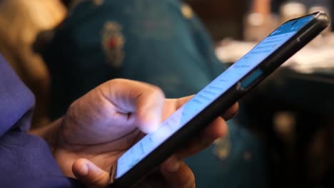 Close-up-of-young-man-hand-using-smart-phone