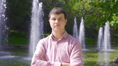 Man-outdoors-looking-dull-at-camera.