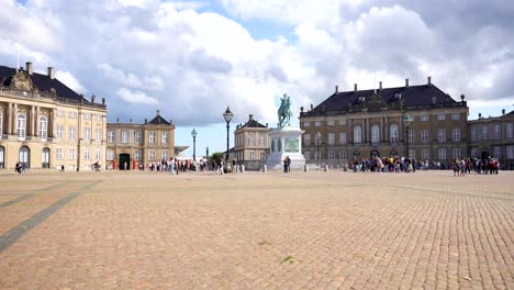 People-walking-around-Amalienborg-Palace-at-daytime-in-Copenhaguen