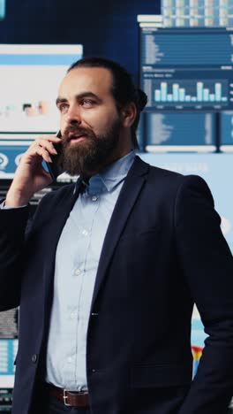 vertical video professional businessman answering a phone call surrounded by kpi metrics