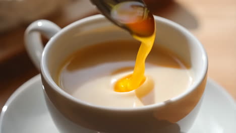 stirring a sweetener into a drink