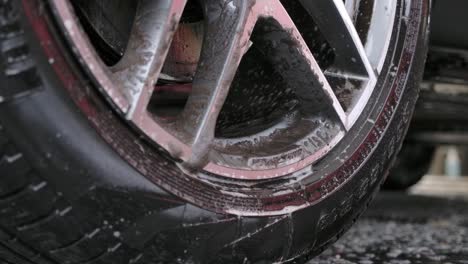 Close-up-Of-A-Dirty-Car-Wheel-Rim-Cleaning-Using-Brush