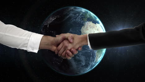 Two-business-people-shaking-hand-in-front-of-globe