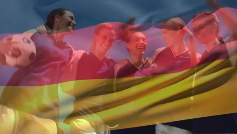 german female football players having fun with a german flag floating on the foreground