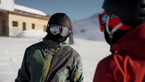 Snowboarders-chatting-before-going-down-the-slope-in-the-winter