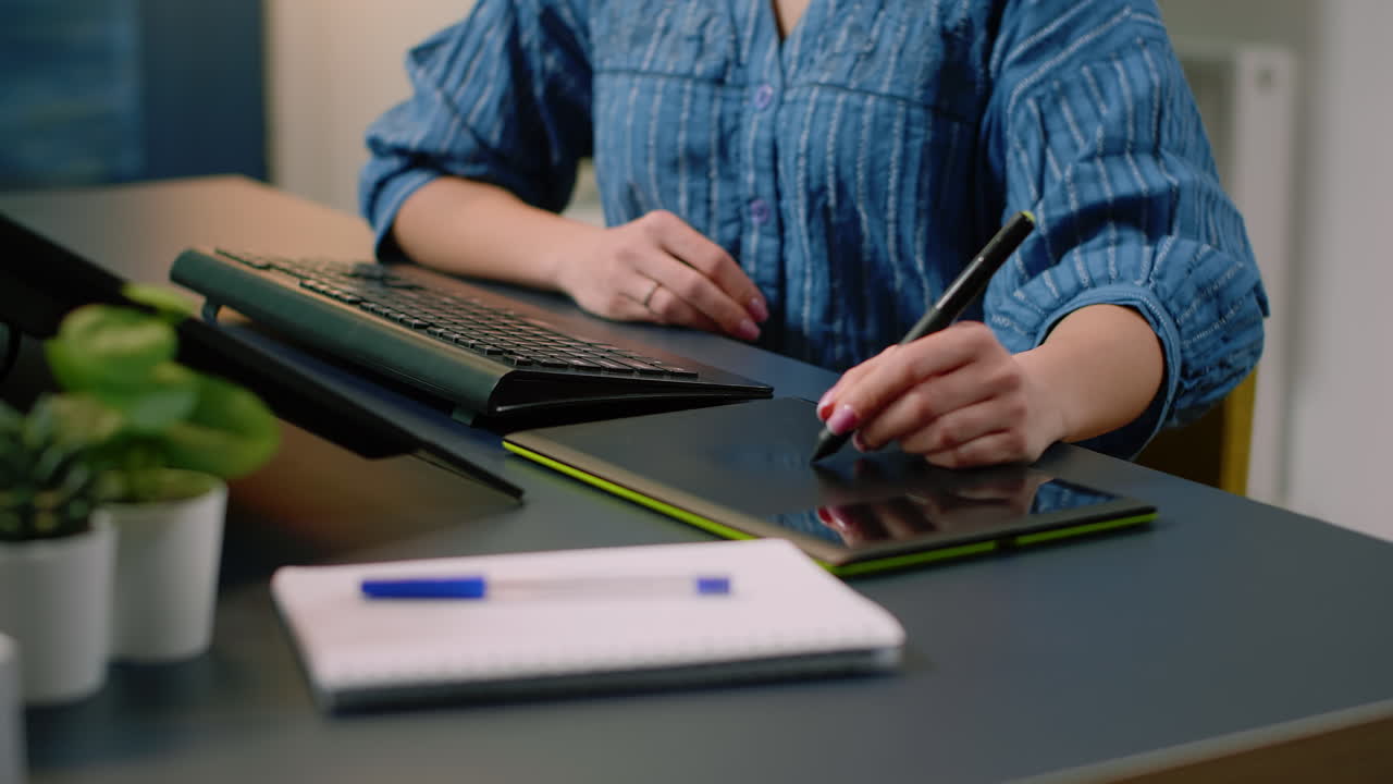 Woman photographer retouching photos with graphic tablet