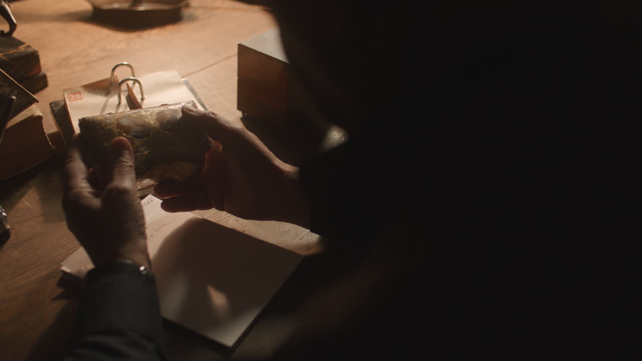 Older passionate man evaluates an old porcelain box