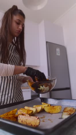 woman cooking roasted potatoes and other vegetables