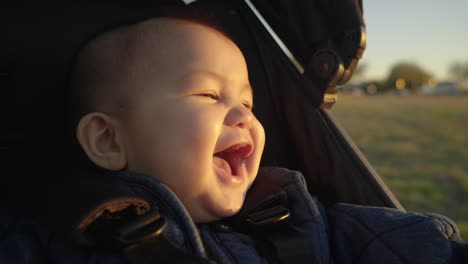 asian baby laughing in stroller. slow motion