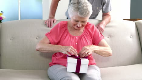 old woman opening her gift