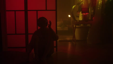 Person Listening to Music and Dancing in a Neon Lit Room