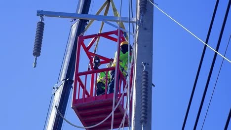 utility workers repairing power lines