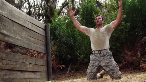 tired military soldier kneeing at boot camp 4k