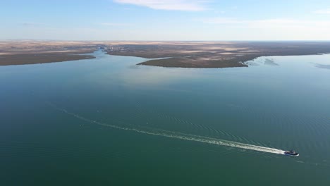 Aerial-landscape,-vessel-cruising-on-Weeroona-island-Peninsula-waters,-Wide-view