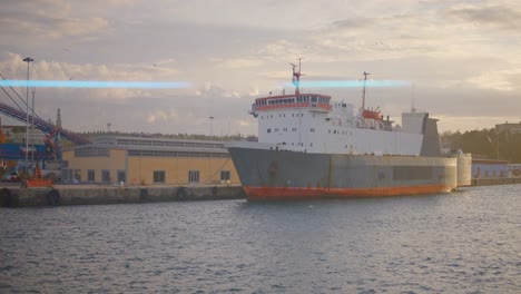 buque de carga en un puerto al atardecer