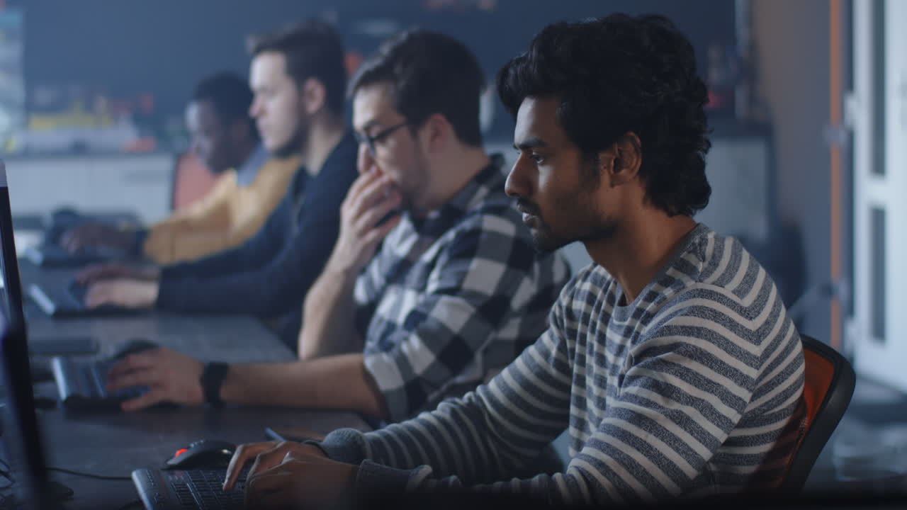 Team of programmers working on computers