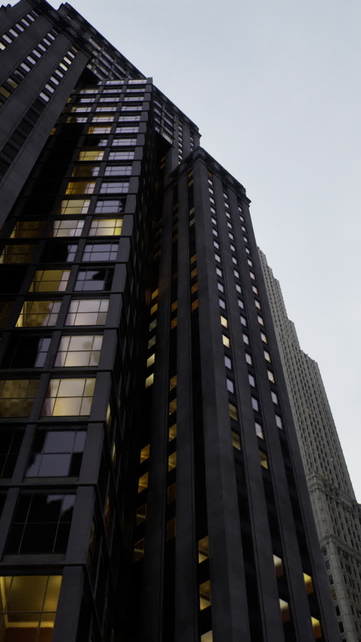 Urban skyline at dusk revealing towering buildings under a cloudy sky