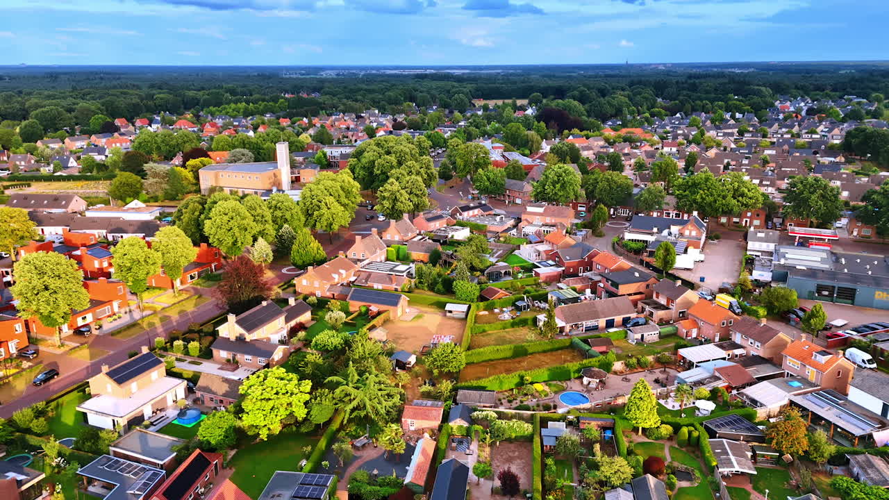 Vibrant suburban neighborhood. Aerial view shows a lush green suburb with houses and gardens during the late afternoon, capturing community life