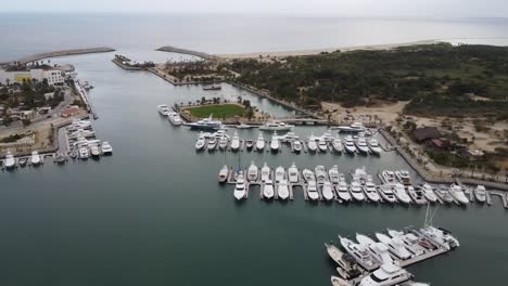 aerial footage of the marina near san jose del cabo in los cabos mexico panning aerial shot of boats in harbor at docks