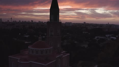sunset over a church in a city