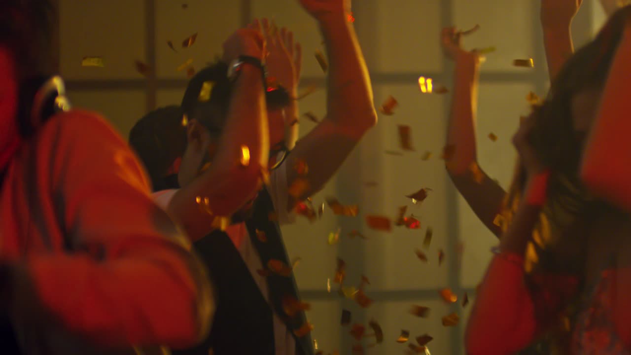 Asian Man Dancing in Confetti Shower
