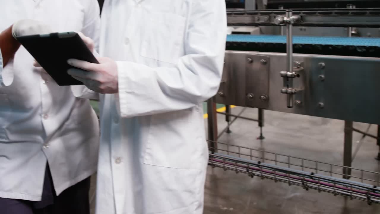 Workers discussing over digital tablet