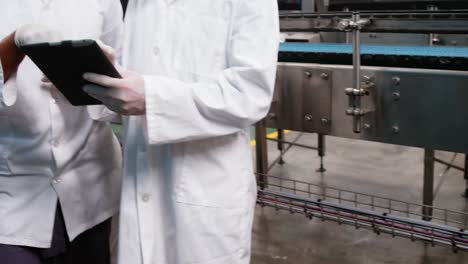 workers discussing over digital tablet