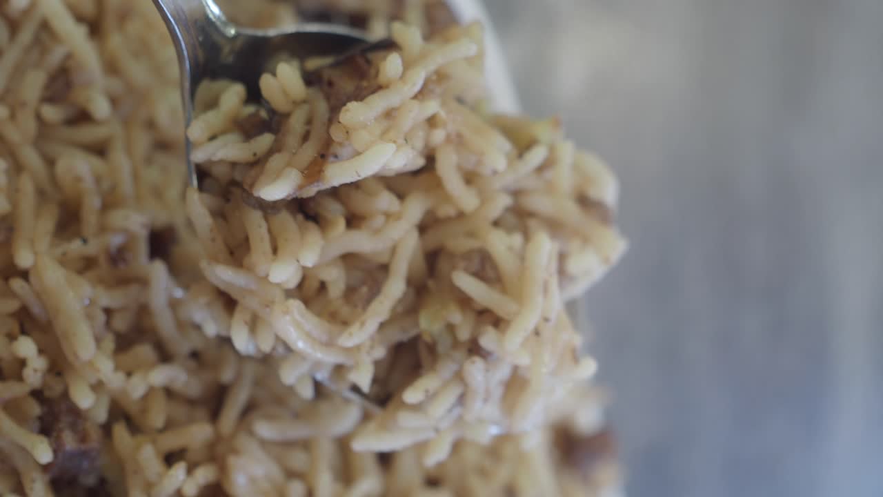 Close-up of a Rice Dish Being Scooped