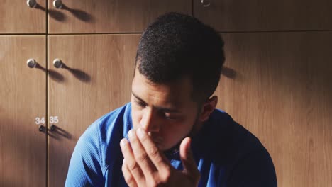 Concentrated-soccer-player-in-the-locker-room