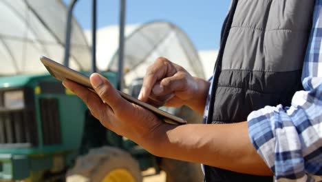 man using digital tablet in blueberry farm 4k