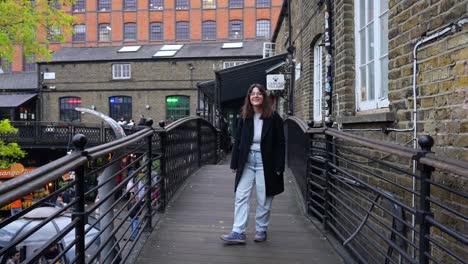 woman walking on a bridge in camden, london