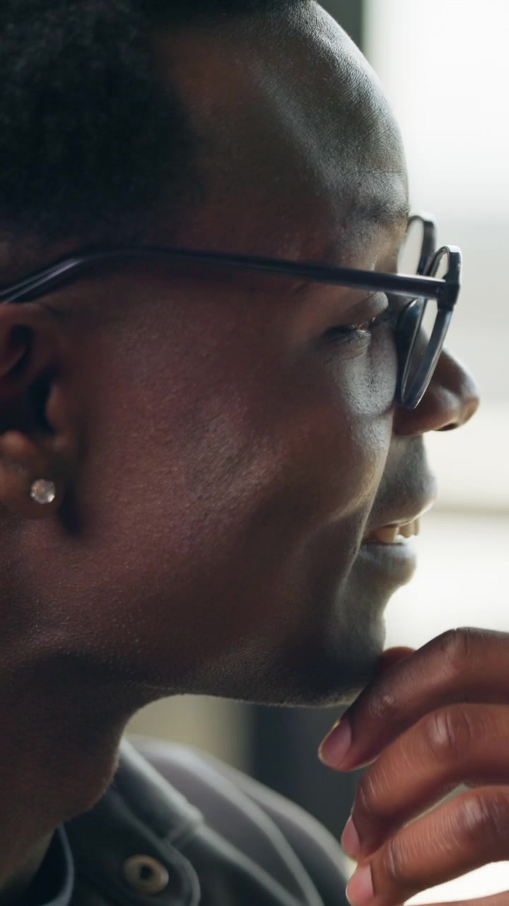 Close-up Profile of a Thoughtful Young Man Wearing Glasses