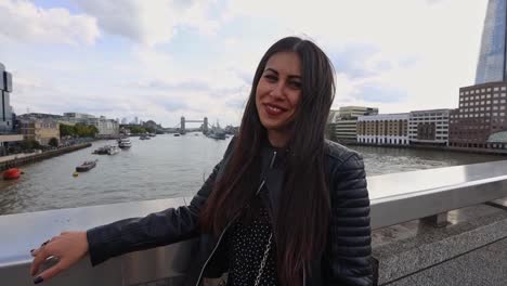 pretty young woman sitting on the london bridge