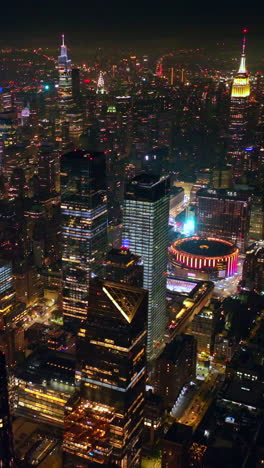 scenic view of outstanding new york sparkling with lights at night time. amazing skyscrapers with shining tops standing out from panorama. top view. vertical video