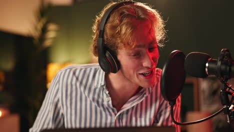 man recording podcast with microphone and headphones