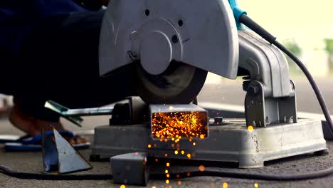 working with angle grinder, cutting pipe
