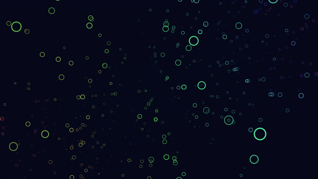 Abstract footage of glowing neon ring particles drifting in a dark space background with soft bokeh depth, ideal for technology, science, data, and futuristic visuals