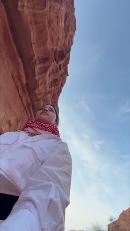 female traveler touching weathered sandstone walls, wandering through an ancient nabataean archaeological site, experiencing historical wonder at petra's iconic rock-carved landmark in jordan