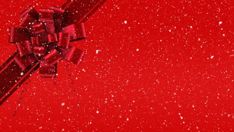 digital animation of red ribbon with gift bow against red background 4k