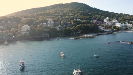 Beautiful-drone-cinematic-aerial-view-distancing-over-the-ocean-of-a-brazilian-paradise-beach-with-white-sand-and-emerald-clear-water-at-sunrise