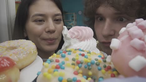 couple enjoying donuts and cupcakes